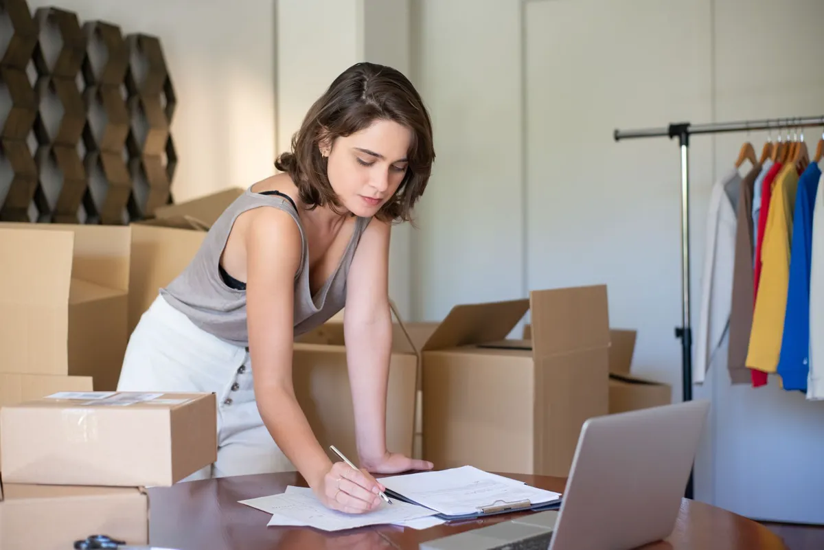 Small business owner managing an online clothing shop from a laptop